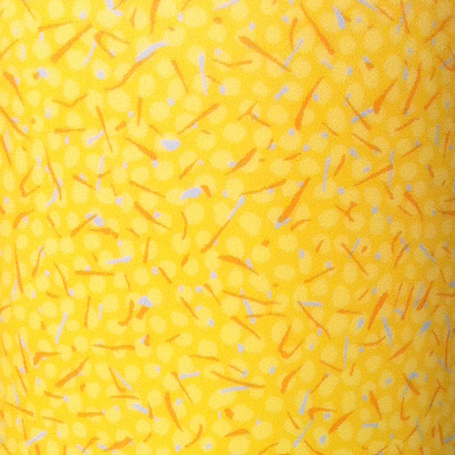 Immagine ravvicinata di una superficie gialla con piccoli punti arancioni, che crea un motivo astratto e vivace.